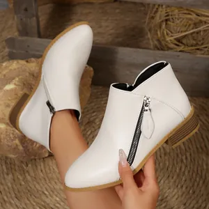 Elegant white pointed-toe ankle boots with dual side zippers and chunky low heels.