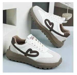 Detailed view of women's retro sneakers featuring heart embroidery and thick platform soles