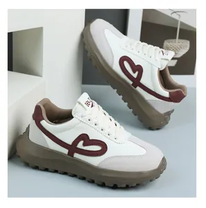 Detailed close-up of retro heart embroidered platform sneakers with durable brown rubber sole