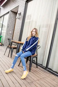 Casual yellow leather loafers for women in a comfortable outdoor lifestyle setting