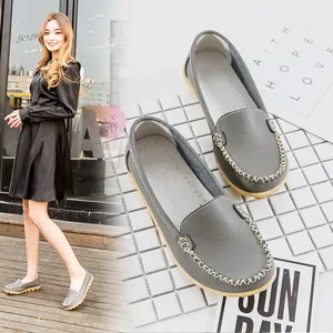 Detailed close-up and lifestyle view of comfortable grey leather flat loafers for women
