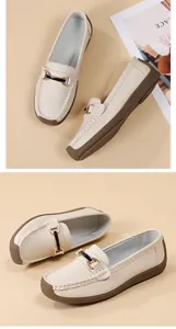 Close-up of beige women's loafers with a soft sole and gold buckle detail.