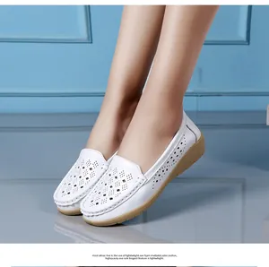 Detailed view of white hollow-out loafers with comfortable wedge soles for women