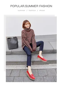 Stylish red thick-sole wedge loafers with metal buckle worn by a model on steps