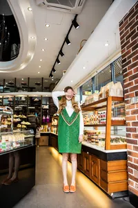 Comfortable orange cowhide flat loafers for women shown in a bright bakery lifestyle shot.