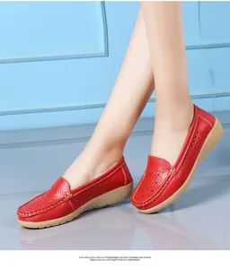 Detailed view of women's red hollow-out wedge loafers with breathable leather design.