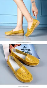 Detailed view of women's yellow hollow-out leather loafers with lightweight wedge sole