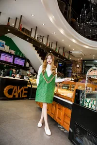 White leather loafers worn by a model in a cafe setting, showing casual flat design