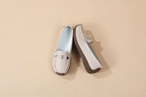 Detailed view of women's soft sole beige loafers with metal buckle and anti-slip sole