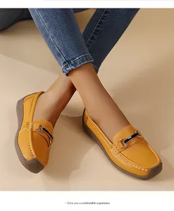 Comfortable yellow leather loafers with soft soles and chic metal buckle detail.