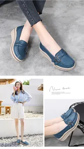 Detail view of blue platform loafers featuring a round toe and silver metal buckle.