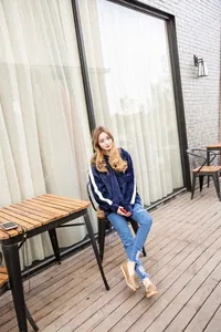 Detailed view of comfortable brown leather loafers worn by a model in an outdoor setting