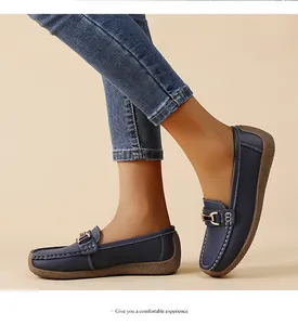Comfortable navy blue women's loafers with soft sole and stylish metal buckle detail.