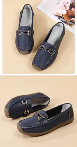 Close-up view of navy blue soft leather loafers featuring a gold buckle and durable rubber sole