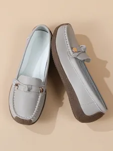 Grey comfortable women's loafers with soft brown rubber sole and gold buckle detail.
