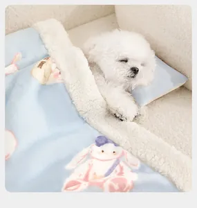 Close-up of white puppy sleeping under a soft blue cartoon rabbit pet blanket