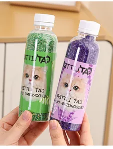 Close-up of green and purple cat litter deodorizing beads in clear plastic bottles