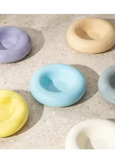Detailansicht bunter Donut-Keramiknäpfe für Haustiere auf Terrazzoboden