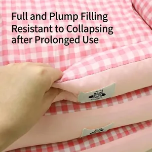 Plump pink gingham pet bed for small dogs and cats, shown with hand-pressed texture detail