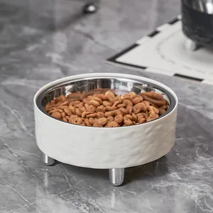 Elevated stainless steel pet bowl with a textured white outer shell and silver legs