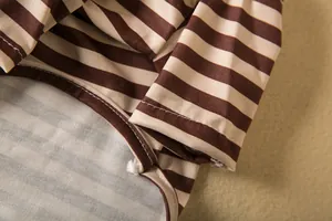 Close-up detail of striped pet shirt showing high-quality stitching and fabric texture.