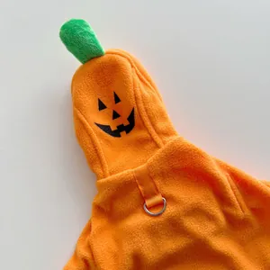 Close-up detail of a soft orange pumpkin pet cloak for cat dog Halloween party.