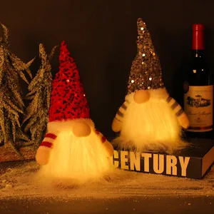 Festive glowing Christmas gnomes dolls with red and grey sequin hats for holiday decor