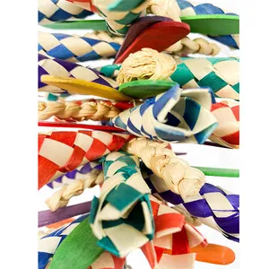 Macro detail of colorful woven straw and wooden sticks on a parrot biting toy