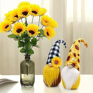 Close-up of two adorable sunflower-themed plush gnomes with vibrant floral accents and hats