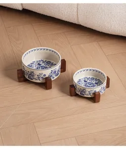 Pair of blue and white floral ceramic pet bowls with acacia wood stands in two sizes