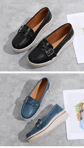 Close-up detail of women's thick sole wedge loafers featuring metal buckle and round toe