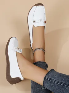 Elegant white slip-on loafers for women featuring soft soles and decorative bows