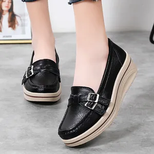 Casual black women's loafers with thick wedge sole and decorative metal buckle detail