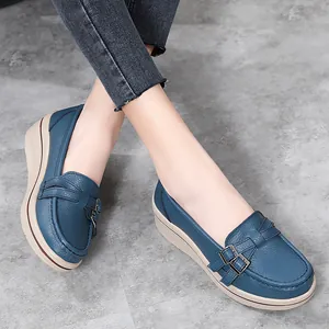 Elegant blue leather wedge loafers for women featuring stylish metal buckle detail