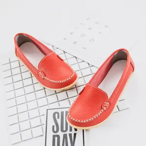 Comfortable red leather loafers for women with flat soles and hand-stitched details