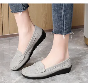 Side view of grey perforated leather loafers with comfortable black rubber soles