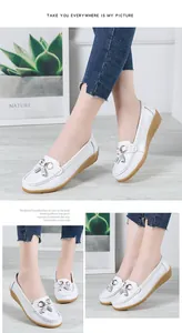 Detailed view of stylish white women's loafers featuring elegant tassels and soft wedge soles
