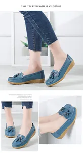 Detailed view of comfortable blue leather loafers with tassels and soft wedge sole for women