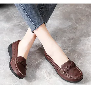 Close-up view of casual brown leather loafers featuring perforated details and braided trim