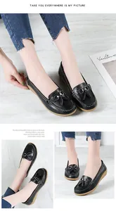 Detail showing black leather loafers with tassel buckle and soft wedge sole unit.