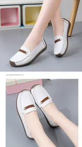Gedetailleerd overzicht van comfortabele witte leren loafers met bruine accenten