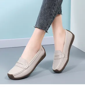 Detailed view of comfortable beige leather loafers for women with soft gum soles