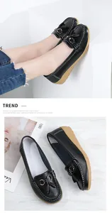Detailed macro view of black faux leather tassel loafers for women with soft rubber sole
