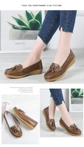 Detailed views of brown leather loafers with tassels and wedge soles for women