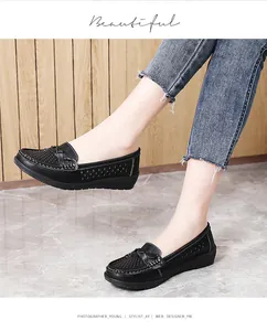 Black perforated women's nurse shoes with comfortable flat soles and knot detail