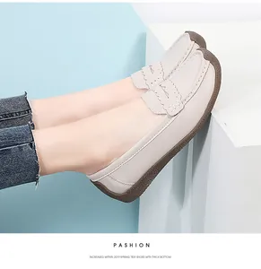 Close-up of comfortable beige loafers with thick rubber soles for women.
