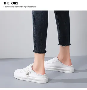 White canvas backless loafers with frayed edges and slip-on design