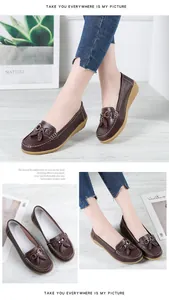 Detailed view of women's brown leather loafers with soft wedge soles and decorative bows