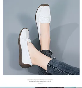 Close-up of white leather loafers with breathable design and durable gum rubber sole.
