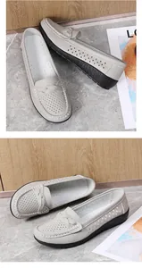 Detailed view of beige perforated casual loafers with braided strap on marble surface.
